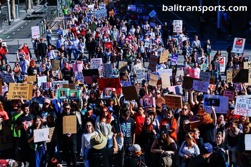Protesters march with placards toward Parliament during the women's rights rally in Melbourne, Australia