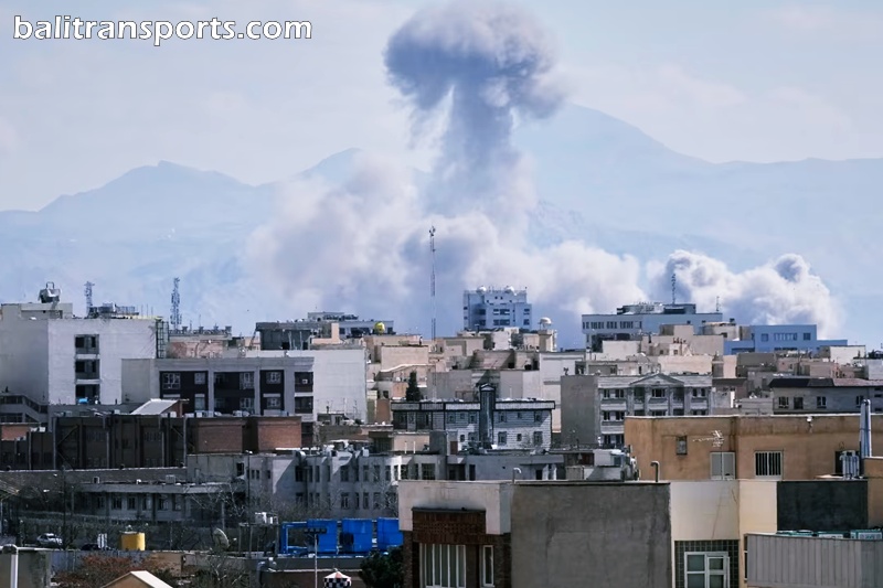 a plume of smoke rises after a strike in Tehran, Iran